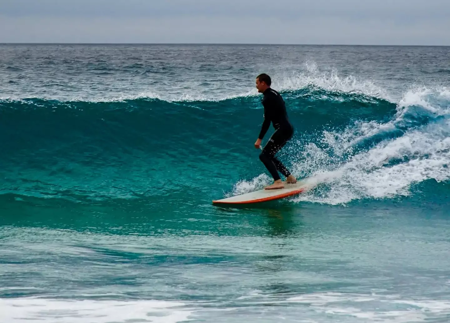 surfing an Newquay beach in Cornwall