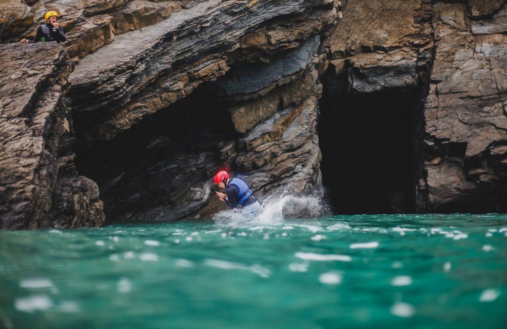 A man coasteering in Cornwall