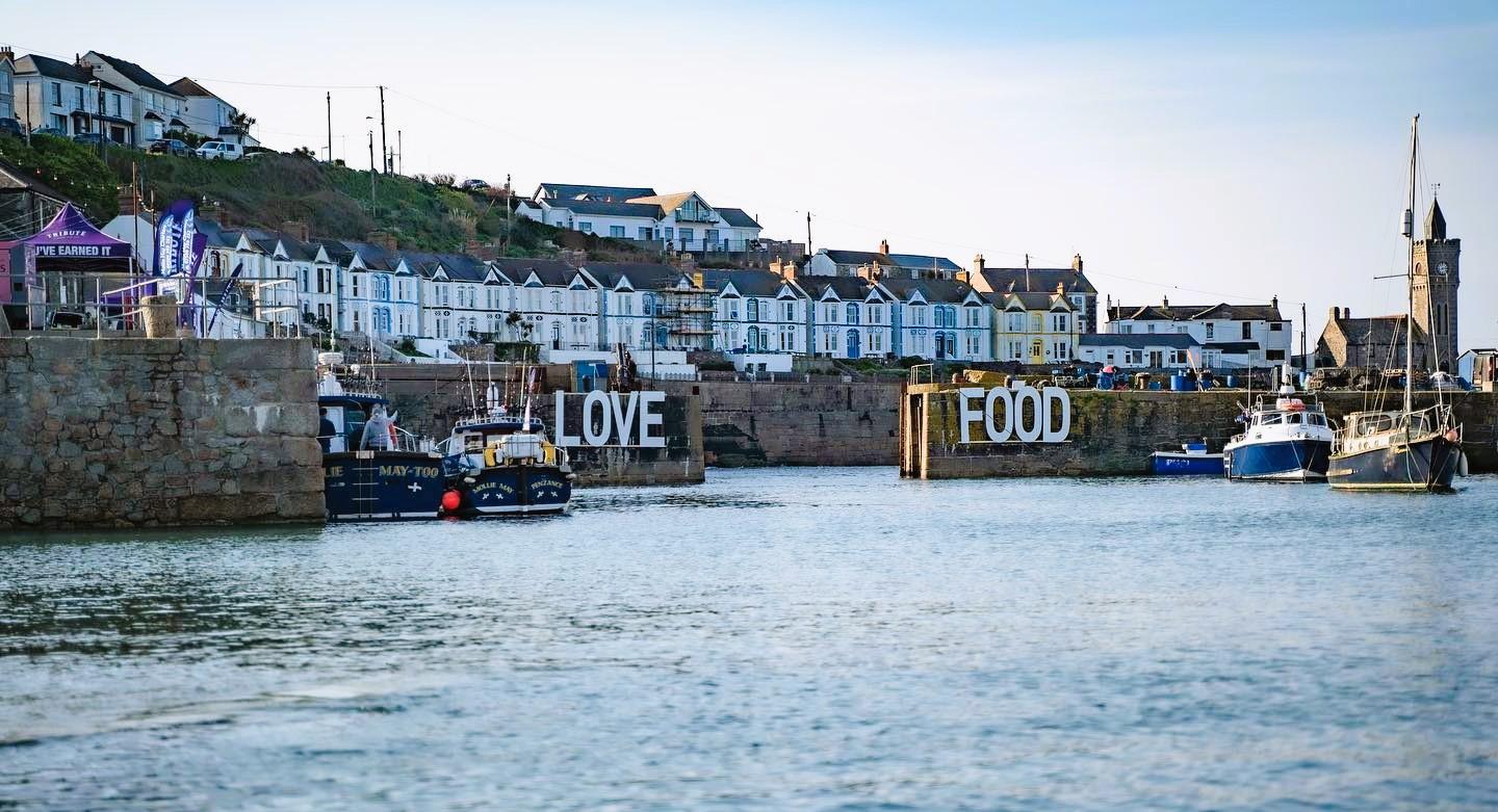 Porthleven food festival sign on the harbour